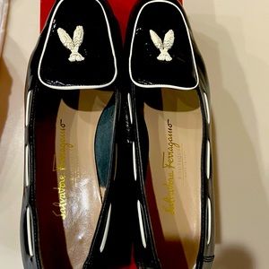 Black patent leather Ferragamo loafers with white accents